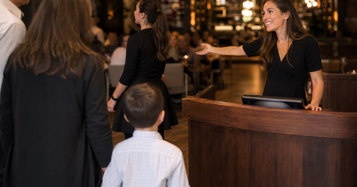 How many hosts should a restaurant schedule at the stand on a Friday night?