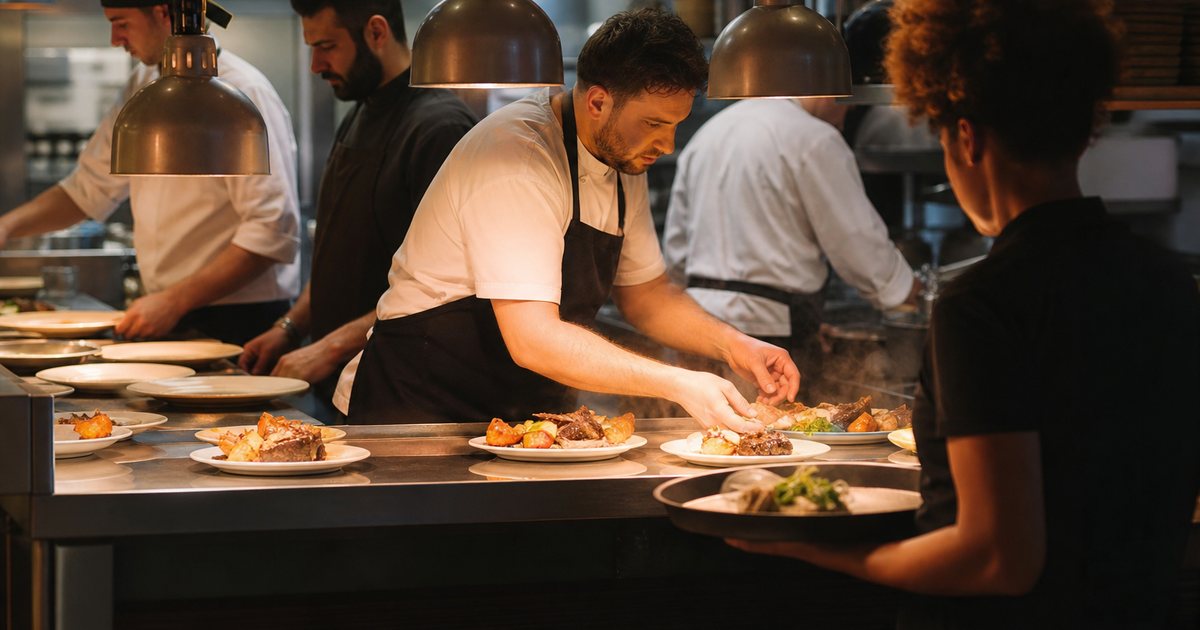 Why does seating guests too fast hurt the kitchen, and when should a host slow down?